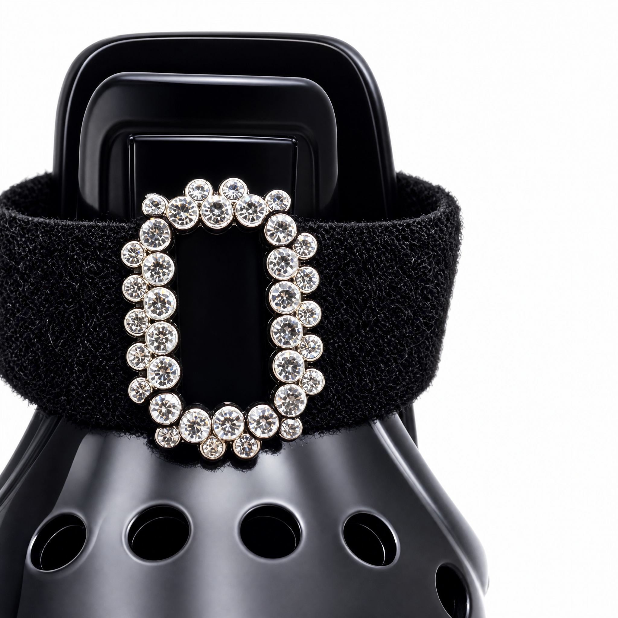 Macro shot of the legendary crystal gemstone square buckle on Blessingmychild black swan dog crocs exuding timeless high fashion