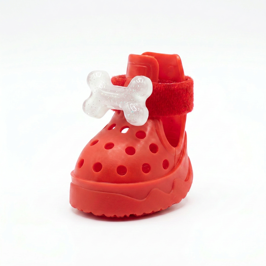 Front view of a premium red jelly dog crocs shoe adorned with a glittering translucent puppy bone charm, white background