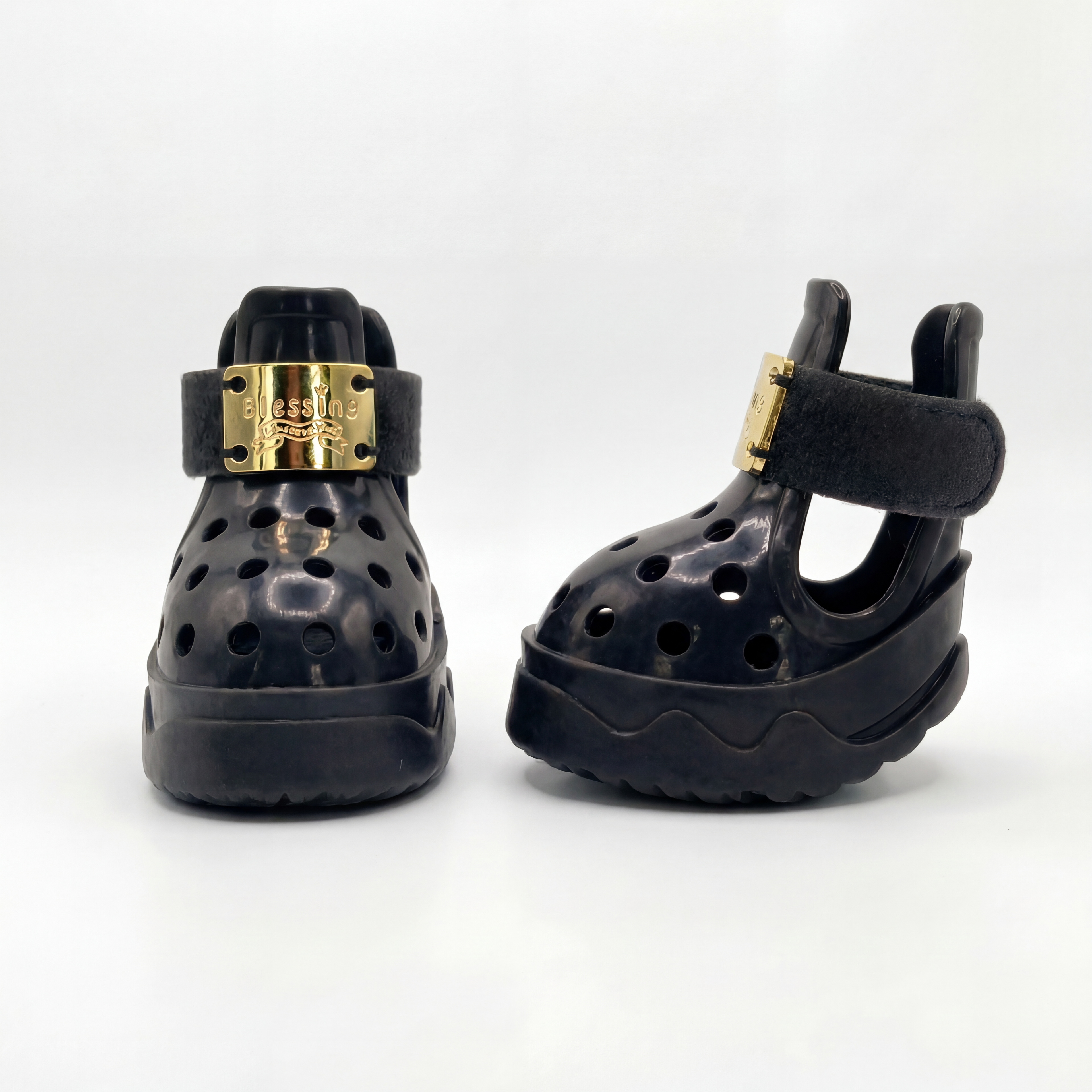 Side and profile view of a pair of Blessingmychild V1 limited edition knight black puppy shoes with premium gold hardware