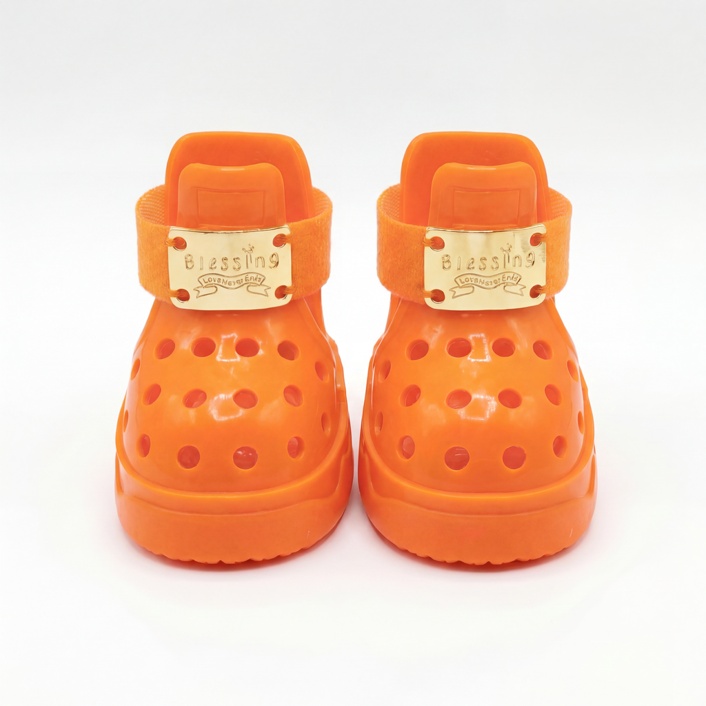 Front closeup of a pair of Blessingmychild V1 limited Kelly Orange dog sandals highlighting the signature brand engraved gold plates