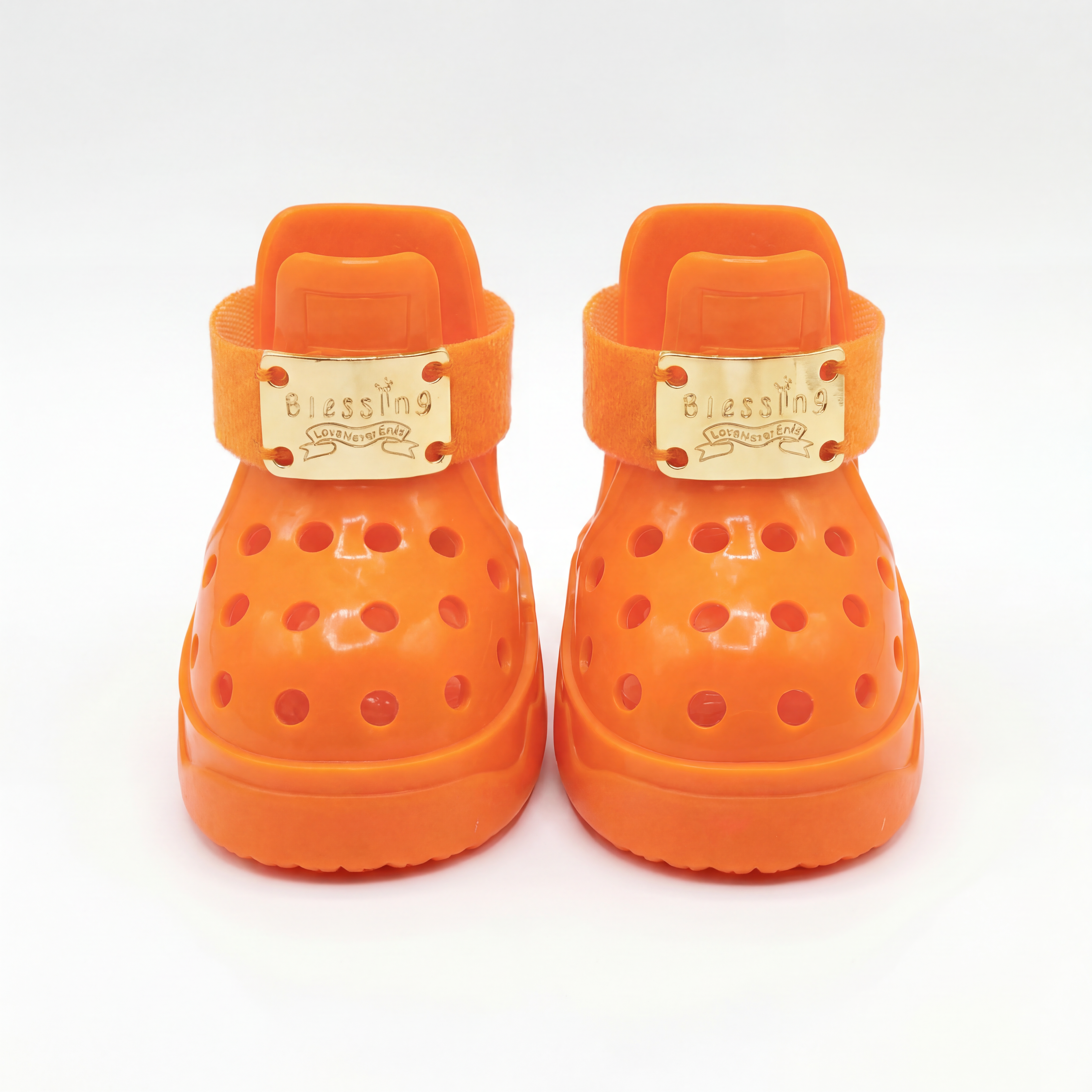 Front closeup of a pair of Blessingmychild V1 limited Kelly Orange dog sandals highlighting the signature brand engraved gold plates