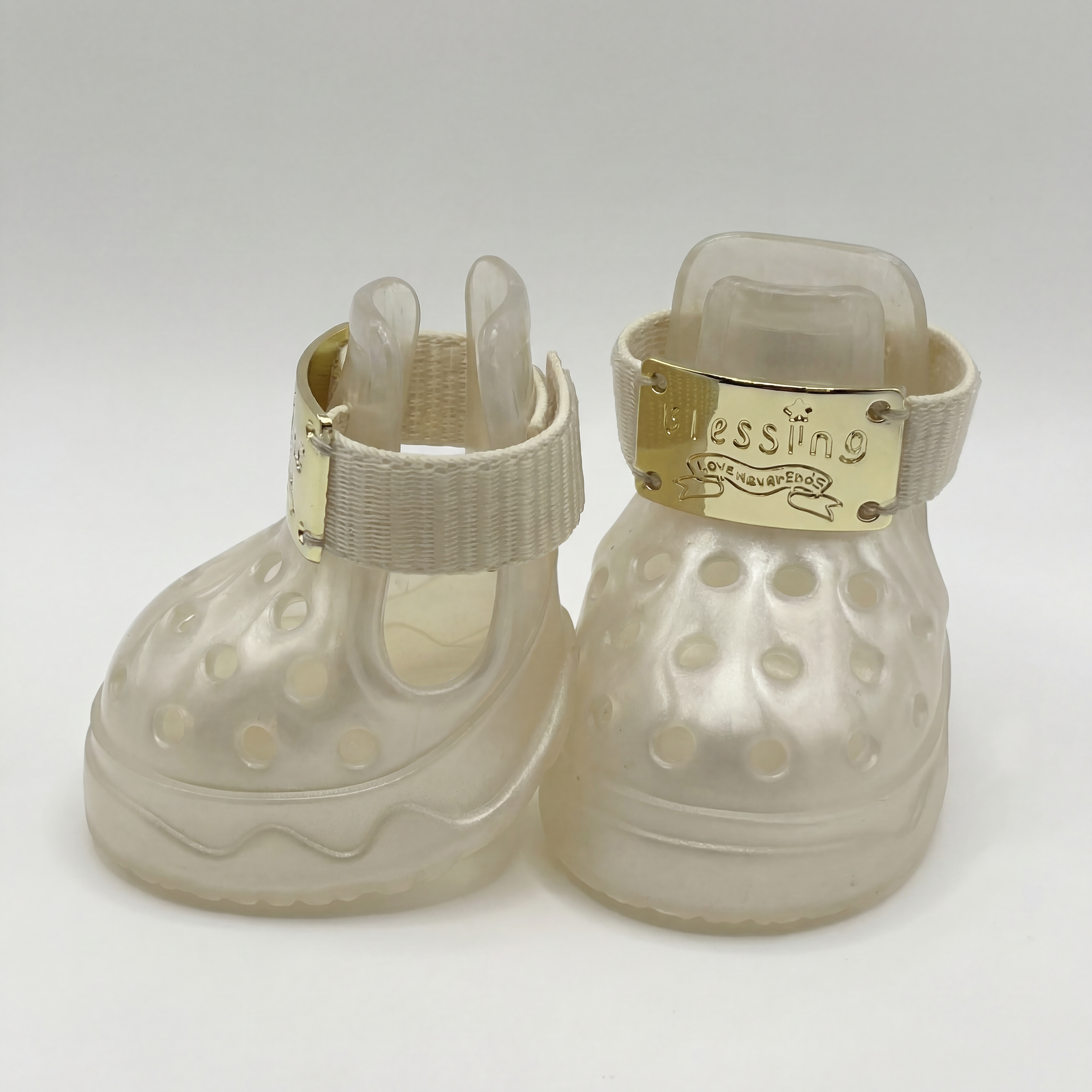 Side and front view of Blessingmychild V1 limited edition pearl white puppy shoes showcasing the breathable cutouts and secure strap